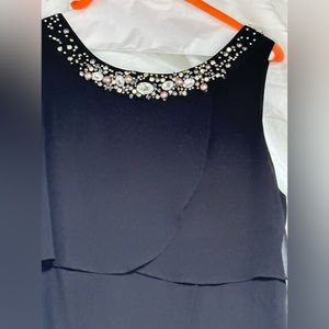 Black chiffon layered gown with beaded neck line.
